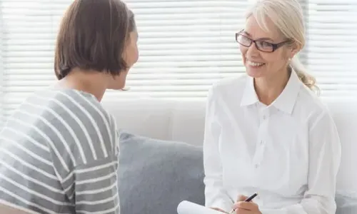 PMHNP Smiling with Patient in Appointment